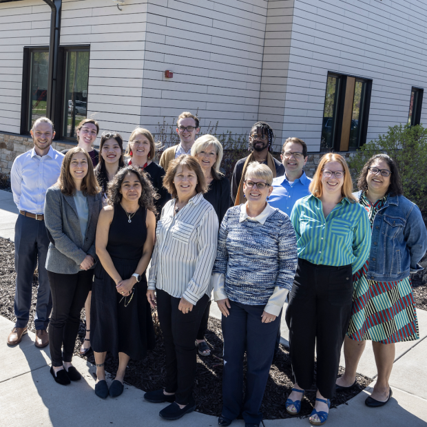 A group photo of the Admission team standing outside their building