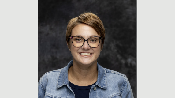 A woman smiles for a headshot