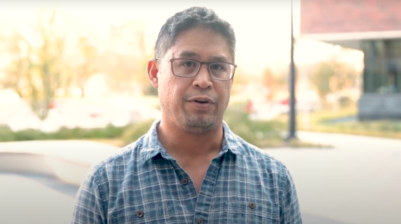 A man speaks to the camera