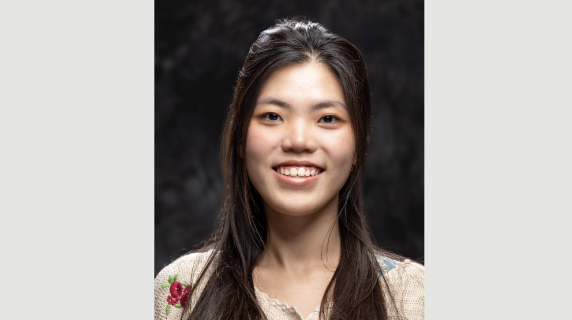 A woman smiles for a headshot