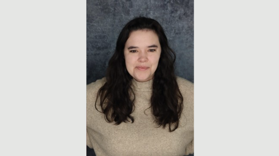 A woman smiles for a headshot