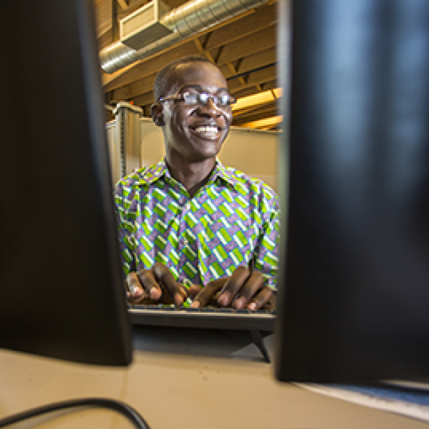 Larry Boateng Asante ’17 between two monitors 