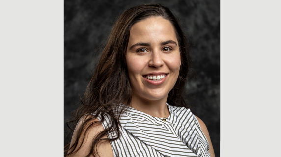 a woman smiles for a headshot