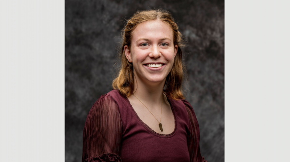 A woman smiles for a headshot