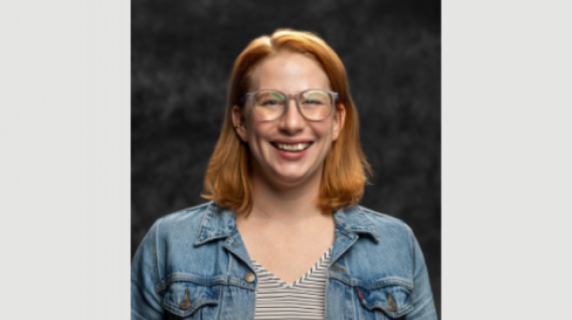 A woman smiles for a headshot